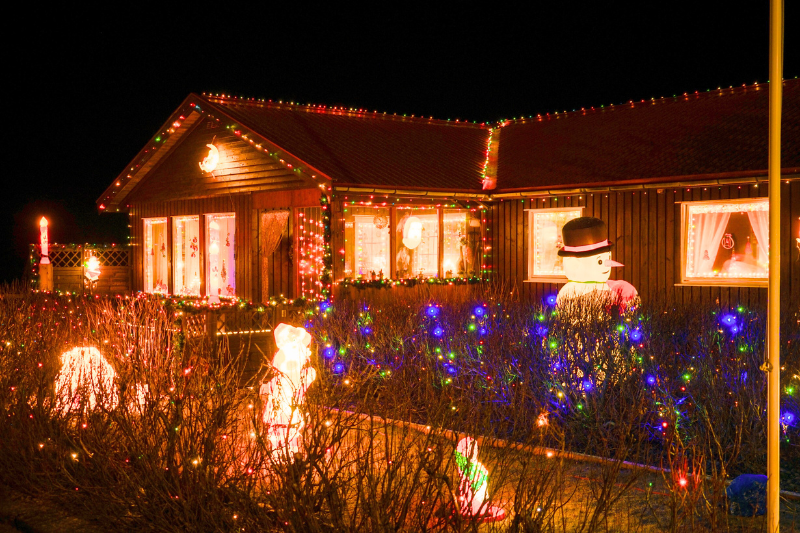 Photo of a house lit up with Christmas lights for holiday electrical safety tips